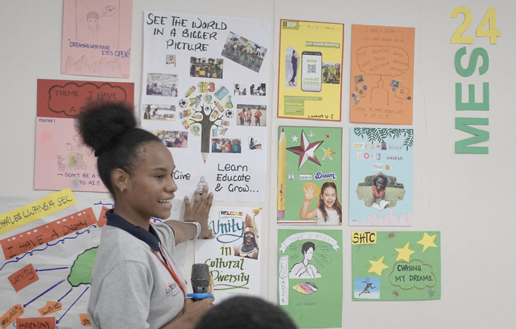 La Salle Technical School Grade 11 student, Ataembo Daya, at a presentation of posters.