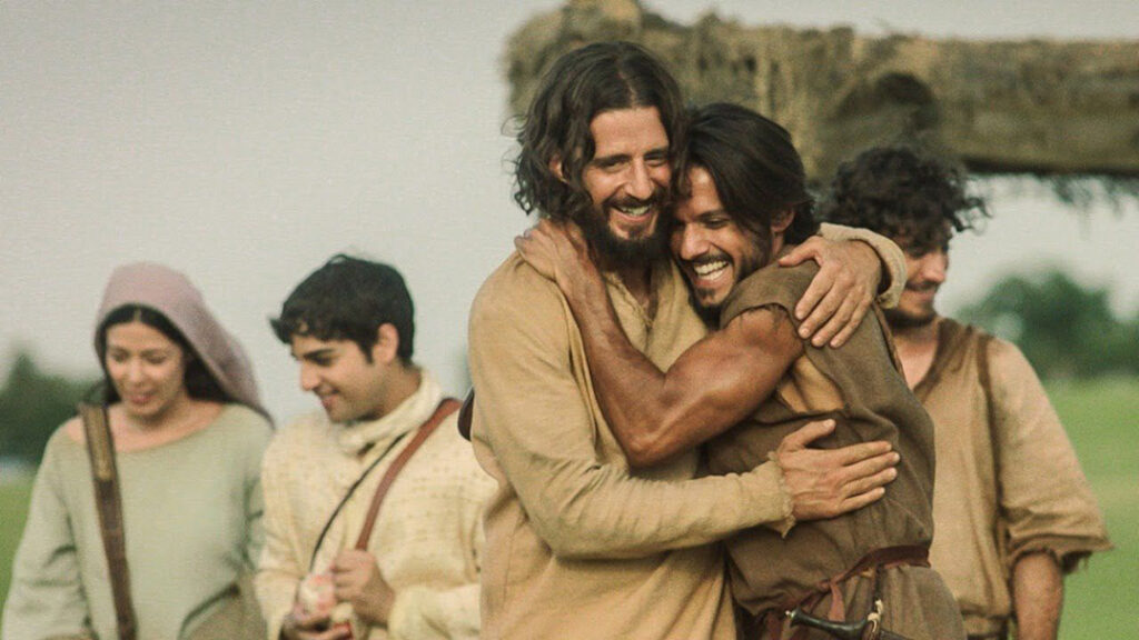 A still from the TV series 'The Chosen,' showing Jesus embracing others.