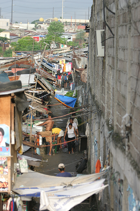 A view of densely packed slum houses in Parañaque, Philippines, symbolizing the mission to reach out to those in marginalized areas.