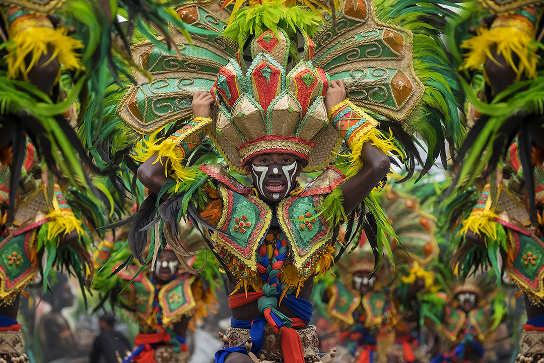 Dancers performing at the Dinagyang Festival, an indigenous religious and cultural celebration in the Philippines.